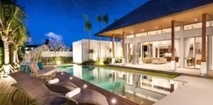 Luxury beachside villa in Goa with private pool, modern outdoor seating, and tropical landscaping at night.